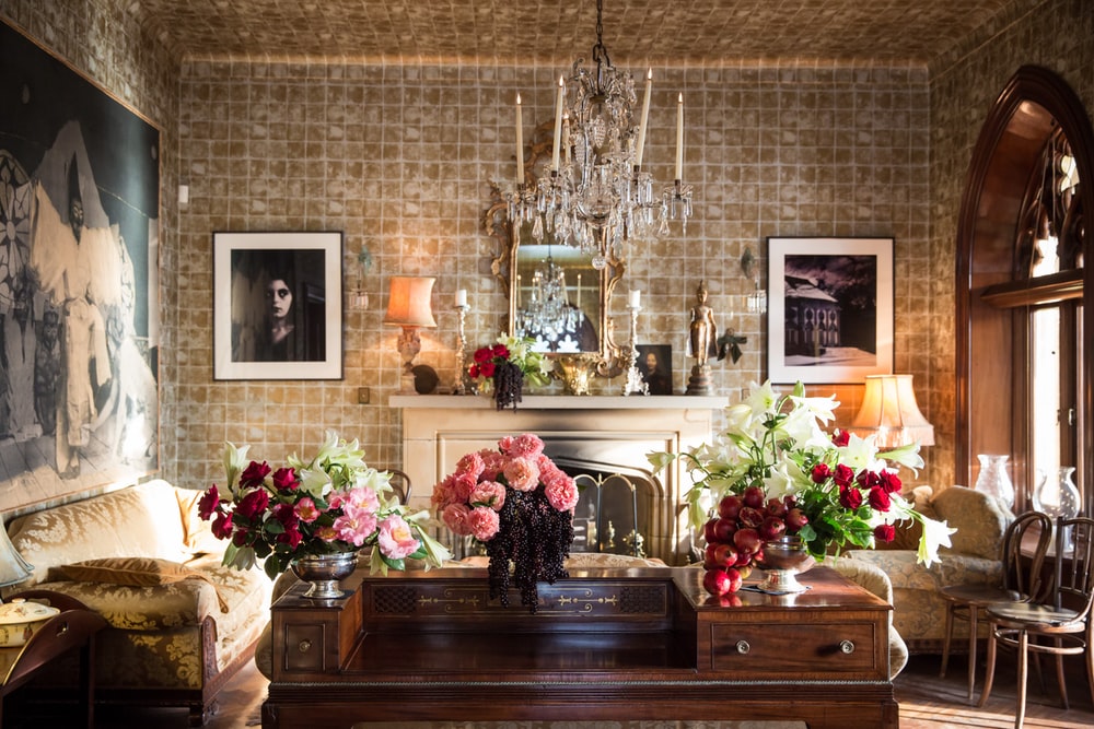Classic antique residential interior with flowers on wooden table, chandelier and wall art in Sydney